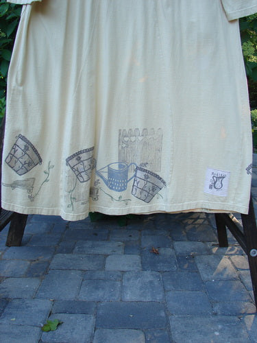 1999 Tea Time Dress Fancy Pot Buttercup Size 2, featuring a feminine hourglass shape with floral pot designs, front elastic-topped pockets, softly rolled neckline, and draw cord back.