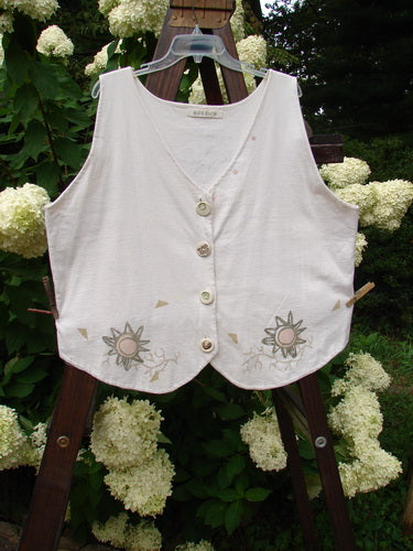 1995 The Folk Vest Warming Sun Star Natural Size 2 featuring a white vest with floral designs, four ceramic stamped buttons, tuxedo-styled front hemline, and upward back scoop hemline.