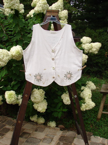 1995 The Folk Vest Warming Sun Star Natural Size 2 displayed on a swinger, featuring a tuxedo-styled front hemline, upward back scoop hemline, and floral design, perfect for cooler months.