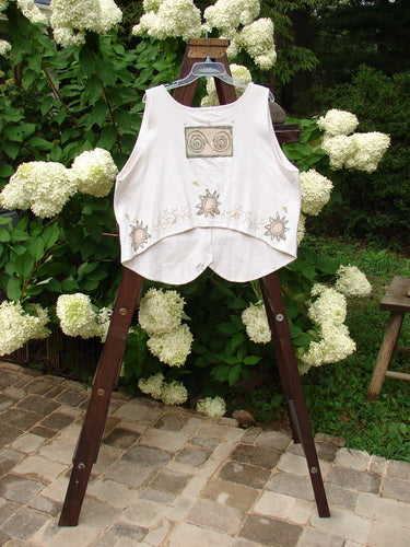 1995 The Folk Vest Warming Sun Star Natural Size 2 on a rack, featuring four ceramic stamped buttons, tuxedo-styled front hemline, upward back scoop hemline, and sun star theme design.