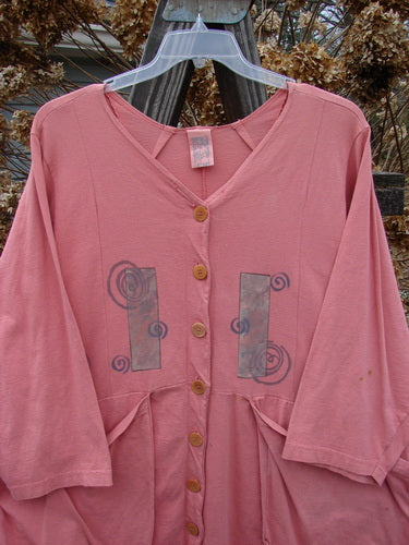 1994 Treasure Jacket Wind Spin Altered Coral OSFA: A pink shirt with a pattern on it, featuring front flop pockets and drop shoulder seams.