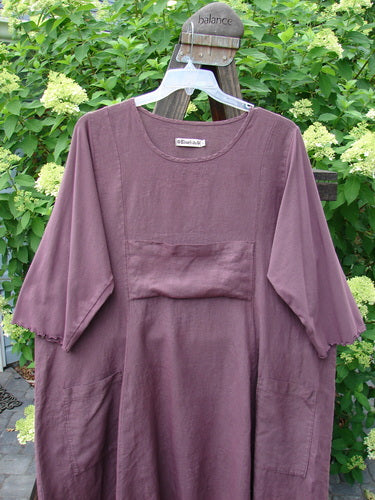 Barclay Linen Cotton Sleeve Upper Pocket Dress Unpainted Red Plum Size 2 on a hanger, showcasing three-quarter sleeves, rounded neckline, and drawcord back for a flattering fit.