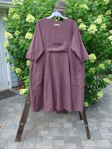 Barclay Linen Cotton Sleeve Upper Pocket Dress Unpainted Red Plum Size 2 displayed on a rack, showcasing its rounded neckline, sectional panels, and three-quarter length sleeves.