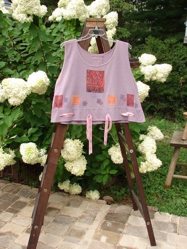 1992 Camisette Top Fire Lavender OSFA displayed on a wooden ladder, showcasing a scooped wider neckline, swingy hemline with button holes, and Blue Fish patch at the back center.