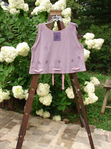 1992 Camisette Top Fire Lavender OSFA displayed on a wooden rack, featuring a scooped neckline, double-paneled, swingy hemline with button holes, and a signature Blue Fish patch on the back.