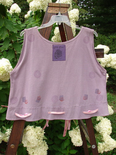 1992 Camisette Top Fire Lavender OSFA displayed on a hanger, featuring a scooped neckline, swingy hemline with button holes, and a variegated ribbon.