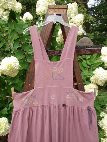 1996 Souvenir Jumper Abstract Path Petunia Size OSFA displayed on a swinger, showcasing its full gathered skirt, criss-cross back, and painted bib.