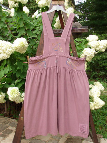 1996 Souvenir Jumper Abstract Path Petunia Size OSFA displayed on a wooden rack, featuring thick straps, a gathered skirt, and a crisscross back, embodying vintage charm from BlueFishFinder.com.