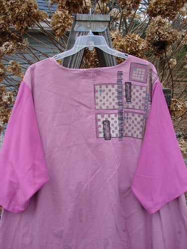 Barclay Cotton Sleeve Hemp Linen Sectional Dress Cobblestone Rose Size 2 displayed on a wooden hanger, featuring a pleated A-line shape, empire waist seam, and contrasting three-quarter length sleeves.