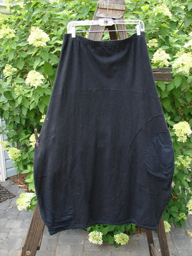 Barclay Cotton Hemp Panel Pocket Circle Skirt Unpainted Black Size 2 hanging on a clothesline, showcasing its full elastic waistline and deep front pockets with visible Celtic Moss accents.
