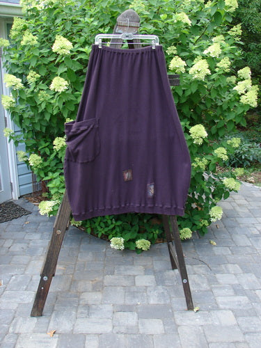 Barclay Patched Thermal Side Pocket Skirt Dream Red Plum Size 2 displayed on a rack, showing its ribbed hemline, vertical panels, oversized side pocket, and full elastic waistline.
