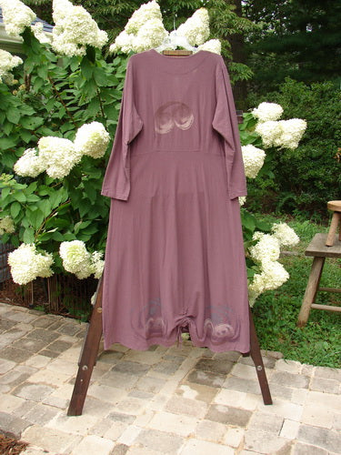 2000 Crepe Tara Dress Celtic Loam Size 1 displayed on a swing, showcasing its long, flowing drape, four tiny pewter buttons, darted bodice, and empire waist.