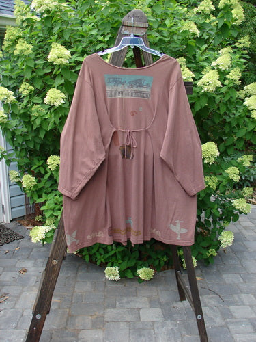 1993 Blueline Jacket Antique Aircraft Dried Rose Size 2 displayed on a hanger. The jacket features unique curved panels and vintage travel-themed details.