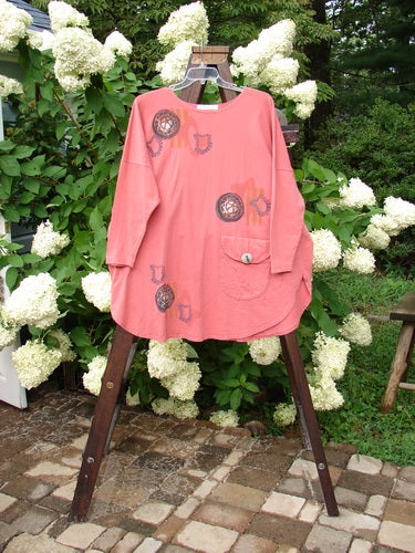 1996 Long Sleeved Pop Top Boulder City Oriole OSFA featuring rounded hemline, scooped neckline, oversized front pocket with ceramic button, and rear drawcord, on a rack.