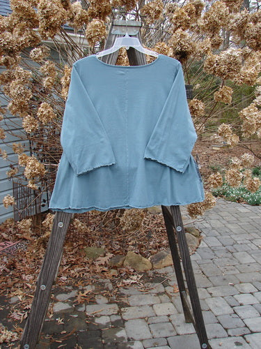Image alt text: Barclay Three Quarter Sleeved Crop A Lined Tee Top in Kingfisher, featuring a blue shirt on a swinger. A-line shape, rounded neckline, sweet curly edgings. Size 2.