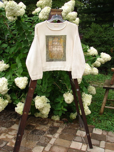 1999 Limited Edition Patched Boxy Pullover Sweater Window Chair Tea Dye OSFA displayed on a hanger, showcasing its square boxy shape, giant front patch design, ribbed sleeves, and softly rolled neckline.