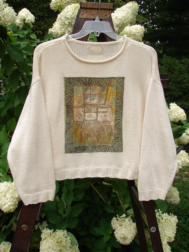 1999 Limited Edition Patched Boxy Pullover Sweater Window Chair Tea Dye OSFA featuring a giant painted front with a thinking chair and window theme, ribbed sleeves and hem, and a softly rolled neckline.