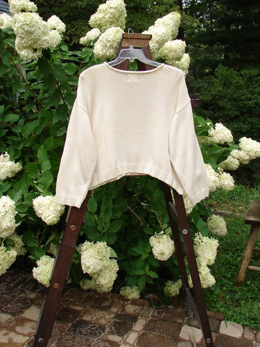 1999 Limited Edition Patched Boxy Pullover Sweater Window Chair Tea Dye OSFA displayed on a wooden swing, showcasing its square boxy shape, ribbed knittery, and giant front patch design.