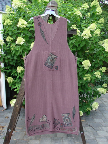 1993 Waffle Pocket Sweater Jumper Heart Feather Dusty Plum Size 2 displayed on a wooden ladder, highlighting its oversized front pocket adorned with a vintage button and unique heart feather theme.