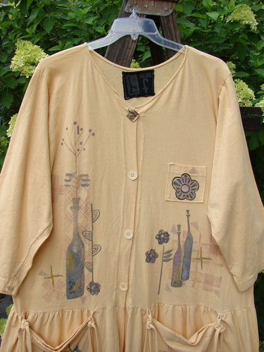 1995 Clothespin Jacket Celebrate Glint OSFA featuring a whimsical flower and bottle design, vibrant painted pockets with long ties, original Blue Fish buttons, and a flared flounce, displayed on a hanger.