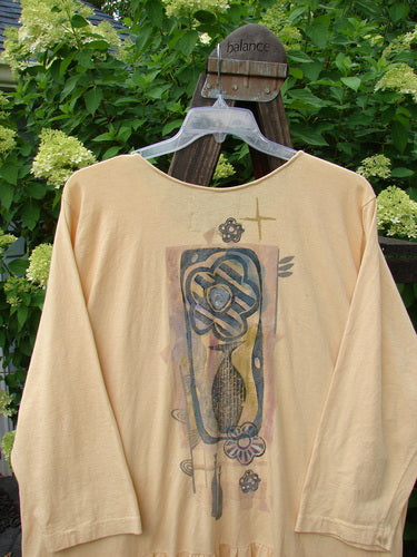 1995 Clothespin Jacket Celebrate Glint OSFA on a wooden hanger, showcasing its long sleeves, flared lower flounce, festive painted design, and two tie-on pockets with blue fish buttons.