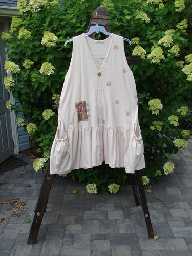 A white dress with pockets on a clothes rack, part of the 1995 Voyager Vest Festive Swan China Size 2 collection.