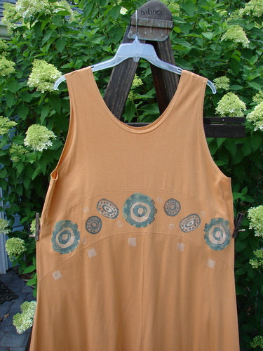 1995 Zelda Jumper Dress Abstract Peachy Keen Size 2 displayed on a swing, showcasing its rounded scooped neckline, downward yoked waist seam, and sweeping A-line shape with a hand-stitched hem.