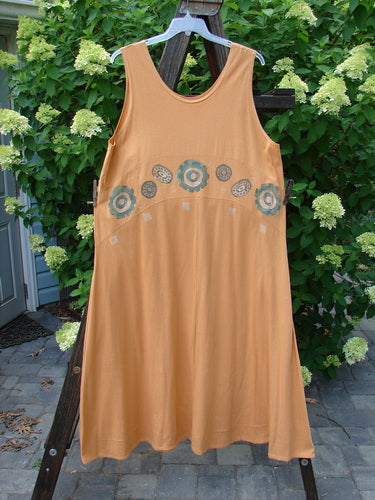 1995 Zelda Jumper Dress Abstract Peachy Keen Size 2, hanging on a clothesline, showcasing a sweeping A-line shape, rounded scooped neckline, and hand-stitched hem with an abstract design.