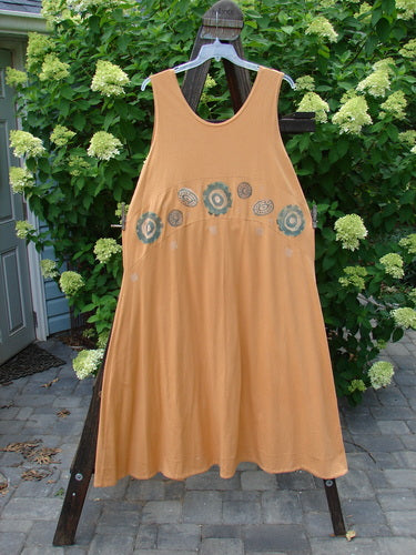 1995 Zelda Jumper Dress Abstract Peachy Keen Size 2 on a rack, showcasing a downward yoke, scooped neckline, sweeping A-line shape, and continuous abstract pattern with a hand-stitched hem.