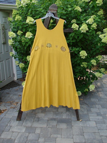 1995 Zelda Jumper Dress Abstract Key Lemon Size 2. A yellow dress with a sweeping A-line shape on a clothesline.