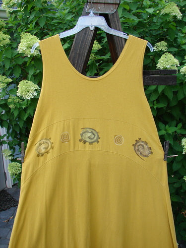1995 Zelda Jumper Dress Abstract Key Lemon Size 2 hanging on a clothesline, showcasing its spiral designs, downward yoked waist seam, and sweeping A-line shape.