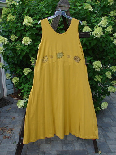 1995 Zelda Jumper Dress Abstract Key Lemon Size 2 hanging on a clothesline, showcasing its downward yoked waist seam, scooped neckline, and sweeping A-line shape with an abstract pattern.