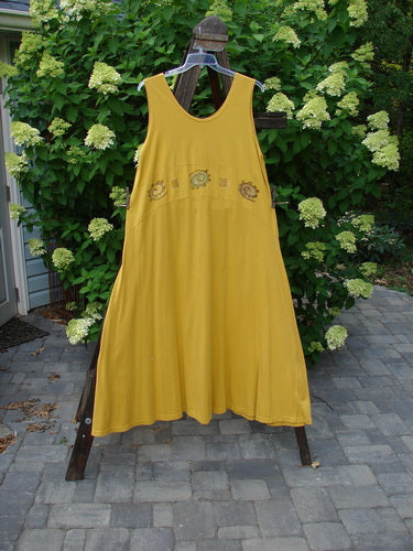 1995 Zelda Jumper Dress Abstract Key Lemon Size 2 on a clothes rack, showcasing its sweeping A-line shape, deeper scooped neckline, and continuous abstract paint design.