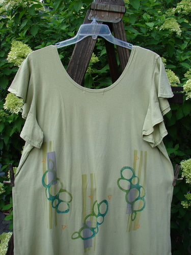 1996 Butterfly Dress Pebble Path Seedling Size 2 displayed on a plastic hanger, highlighting its ruffled sleeves and hem, deep rounded neckline, and slight A-line shape.