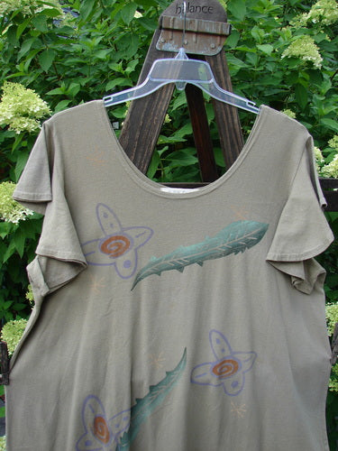 1996 Butterfly Dress Feather Flower Nest Size 2 displayed on a hanger, featuring shorter ruffled sleeves, lower ruffled hem flounce, deep rounded neckline, and slight A-line shape in lightweight organic cotton.