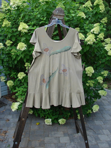 1996 Butterfly Dress Feather Flower Nest Size 2 displayed on a swing, showcasing shorter ruffled sleeves, a coordinating lower ruffled hem flounce, and a deep rounded neckline.