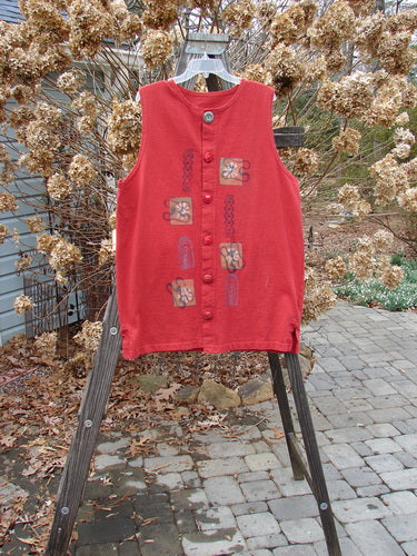 1996 Symbol Vest Gateway Pomegranate Size 1: A red vest with designs on it, made from heavy weight organic cotton. Vintage oversized button, knotted and textured chunky buttons, slightly shallow neckline, tiny vented sides, straighter shape. Bust 48, waist 48, hips 48, length 32 inches.