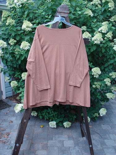 Barclay Triangle Cardigan Unpainted Dusty Ochre Size 2 on a hanger, showcasing a deep V neckline, angled front pockets, and a widening lower hem with original buttons.
