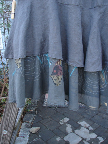 Barclay Linen Two Tier Ruffle Skirt Angel Fish Storm Grey Size 2 with a face design, featuring a double A-line fall and significant lower batiste ruffle painted with an angelfish theme.