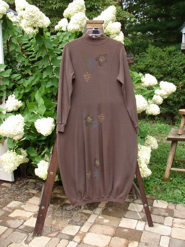 1996 Thermal Day Dress Celestial Molasses Size 2 displayed on a swing, highlighting its hourglass shape, ribbed cuffs and hemline, mock rib T-neck, and celestial-themed paint.