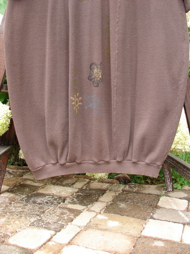 1996 Thermal Day Dress Celestial Molasses Size 2 displayed on a bench, showcasing its unique ribbed hemline, mock rib T-neck, and celestial theme pattern.