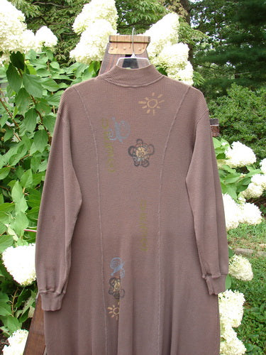 1996 Thermal Day Dress Celestial Molasses Size 2: A brown, long-sleeved, cotton thermal dress with ribbed cuffs, hemline, and mock ribbed neck, featuring celestial-themed paint and rounded vertical seams.