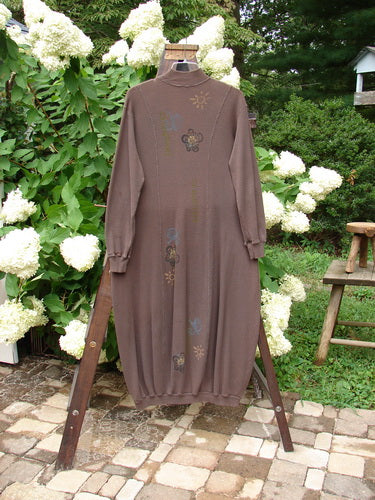 1996 Thermal Day Dress Celestial Molasses Size 2 displayed on a swing, showcasing its long sleeves, hourglass shape, ribbed cuffs, and unique hemline with celestial-themed paint accents.