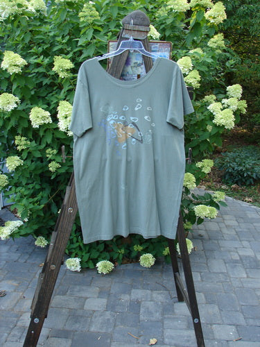 1996 Everyday Dress Step Stone Cricket Size 2 displayed on a hanger, showcasing its wide shape, draw cord accent, shallow neckline, and unique stepping stone theme paint.
