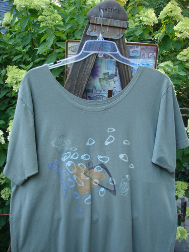 1996 Everyday Dress Step Stone Cricket Size 2 displayed on a hanger, highlighting its wide shape, draw cord accent, and stepping stone theme paint. Visible lightweight organic cotton fabric with a shallow neckline and slightly tapering shape.