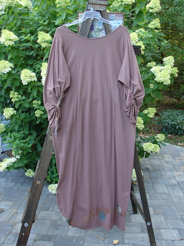 1994 Deep Neck Dress Embellished Forest Dusty Plum Size 2 on a wooden stand, showcasing its deep neckline, fish embellishments, mixed silk and cotton ribbons, and tapering lower hem.