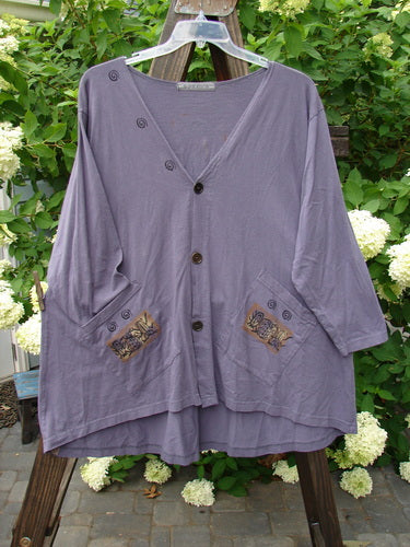 1996 Triangle Cardigan Garden Bug Purple Martin OSFA displayed on a hanger, featuring a deep V neckline, scooped hemline, angled front pockets, and a garden bug theme.