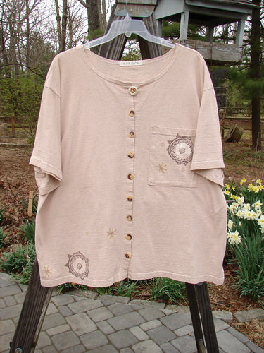 1994 Camp Shirt Fish Medallions Natural Flaxen Size 2: A shirt with fish and medallion designs, wider sleeves, and a varying hemline.