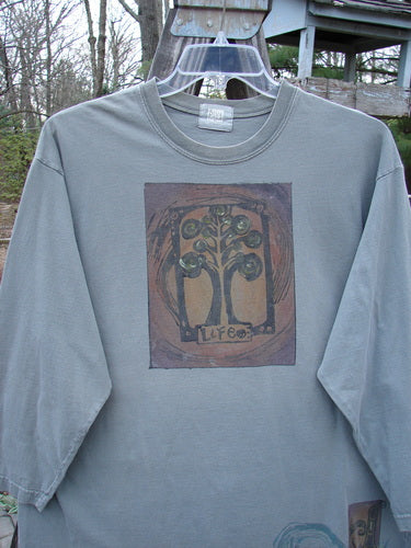 2000 Long Sleeved Tee Tree of Life Park Size 1: A long-sleeved shirt with a colorful tree design, featuring a ribbed neckline, drop shoulders, and a straight, generous shape made from mid-weight organic cotton.