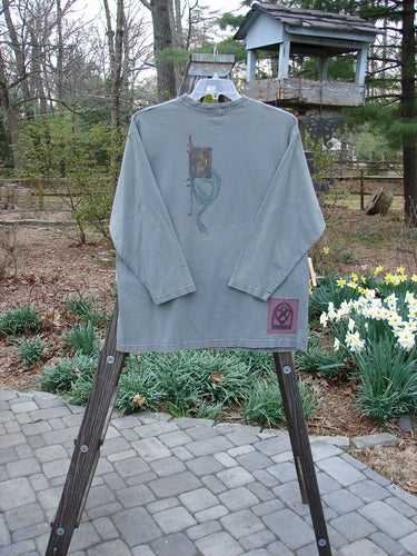 2000 Long Sleeved Tee Tree of Life Park Size 1 displayed on a rack, showcasing a colorful Tree of Life design, drop shoulders, and a rolled ribbed neckline.